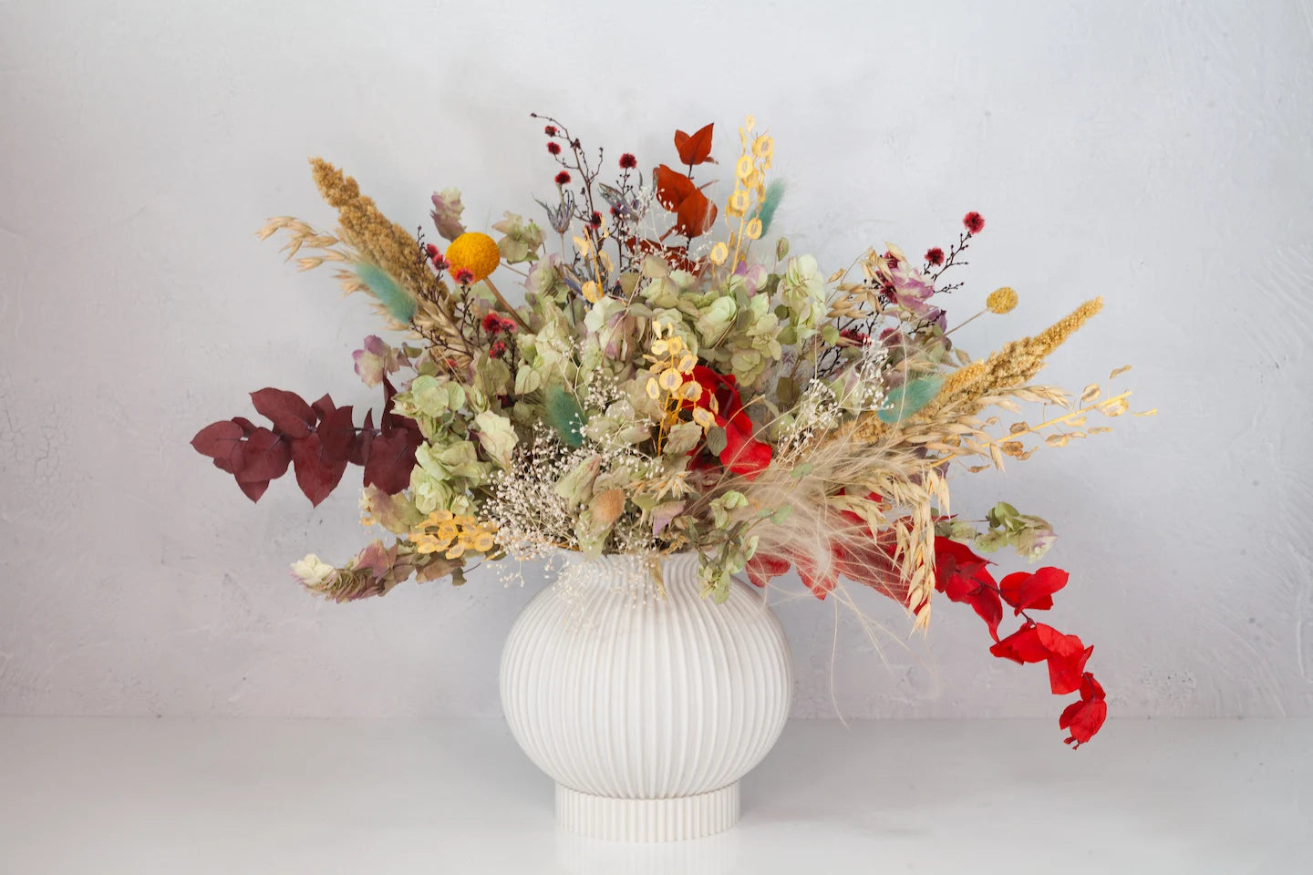 Bleached and dried neutral bouquet with a bit of color from Verbena.